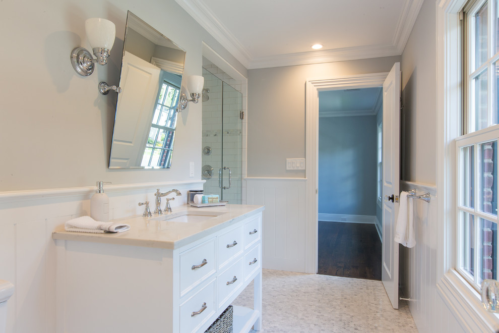 Photo of a large contemporary shower room bathroom in New York with freestanding cabinets, white cabinets, an alcove shower, a one-piece toilet, grey walls, ceramic flooring, a submerged sink and quartz worktops.