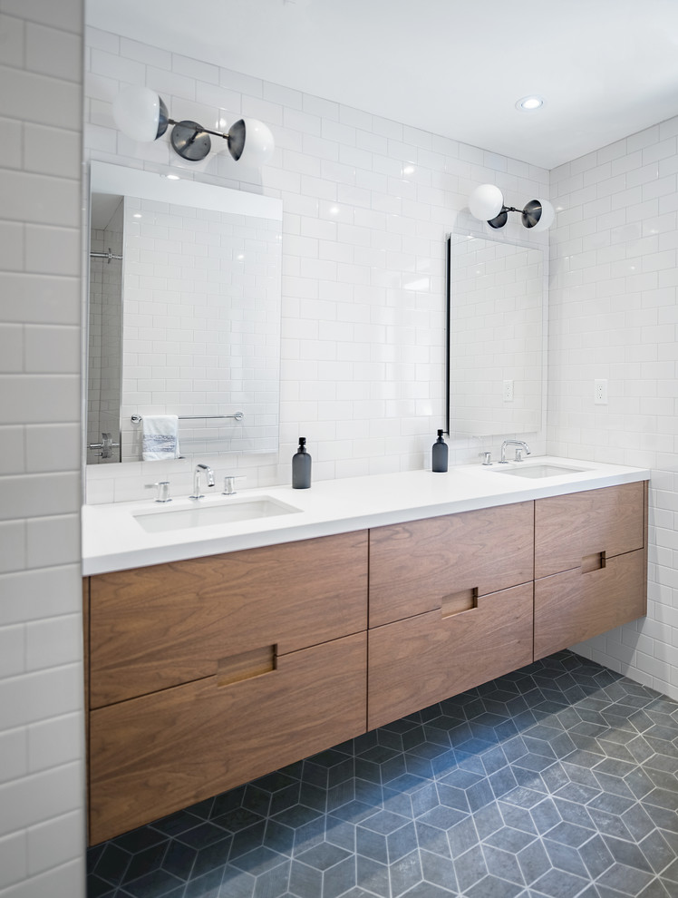 Large modern ensuite bathroom in Toronto with flat-panel cabinets, medium wood cabinets, white tiles, metro tiles, white walls, slate flooring, a submerged sink, engineered stone worktops and grey floors.