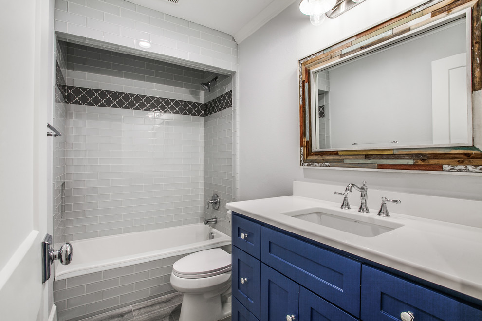 Inspiration for a mid-sized timeless kids' glass tile porcelain tile and gray floor bathroom remodel in Dallas with shaker cabinets, blue cabinets, a two-piece toilet, gray walls, an undermount sink and quartz countertops
