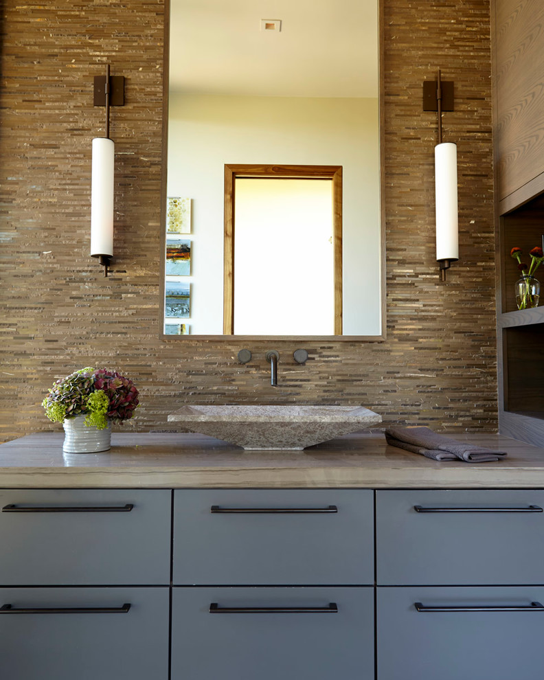 This is an example of a small contemporary shower room bathroom in San Francisco with flat-panel cabinets, dark wood cabinets, a two-piece toilet, grey tiles, cement tiles, multi-coloured walls and an integrated sink.