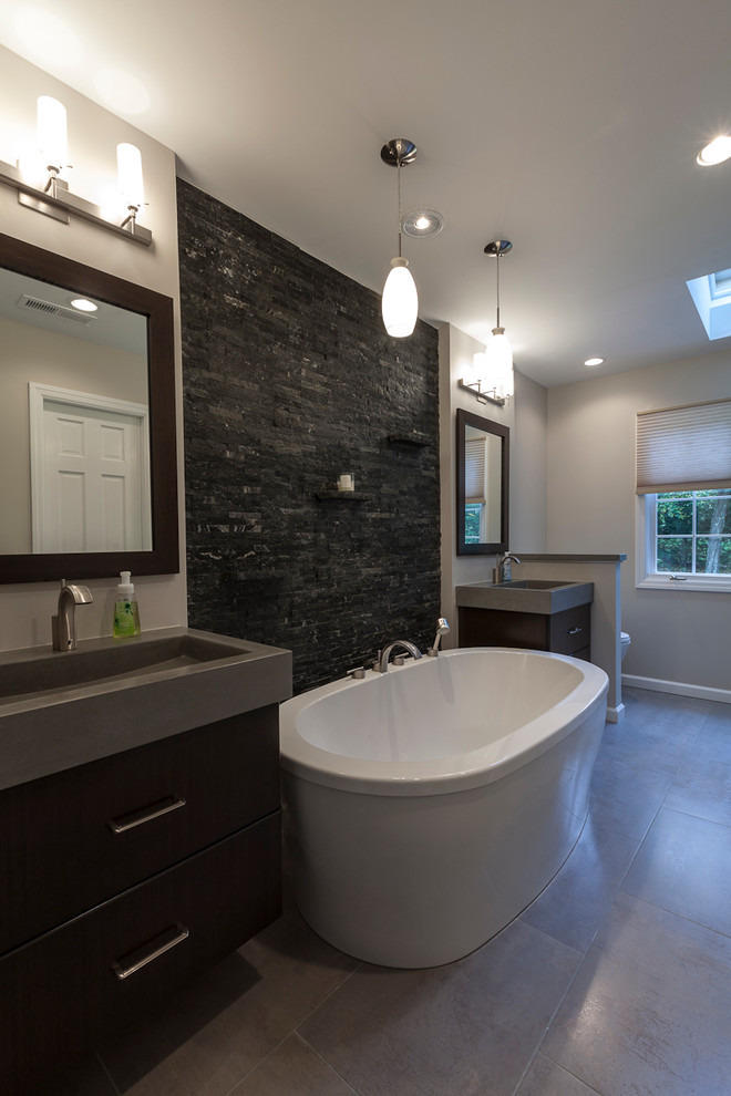 Large trendy master multicolored tile and matchstick tile porcelain tile and gray floor bathroom photo in New York with flat-panel cabinets, dark wood cabinets, a two-piece toilet, gray walls, an integrated sink, concrete countertops and a hinged shower door