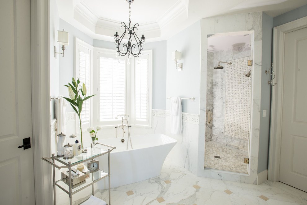 Design ideas for a traditional bathroom in Portland with a freestanding bath, an alcove shower, white tiles, blue walls and marble flooring.