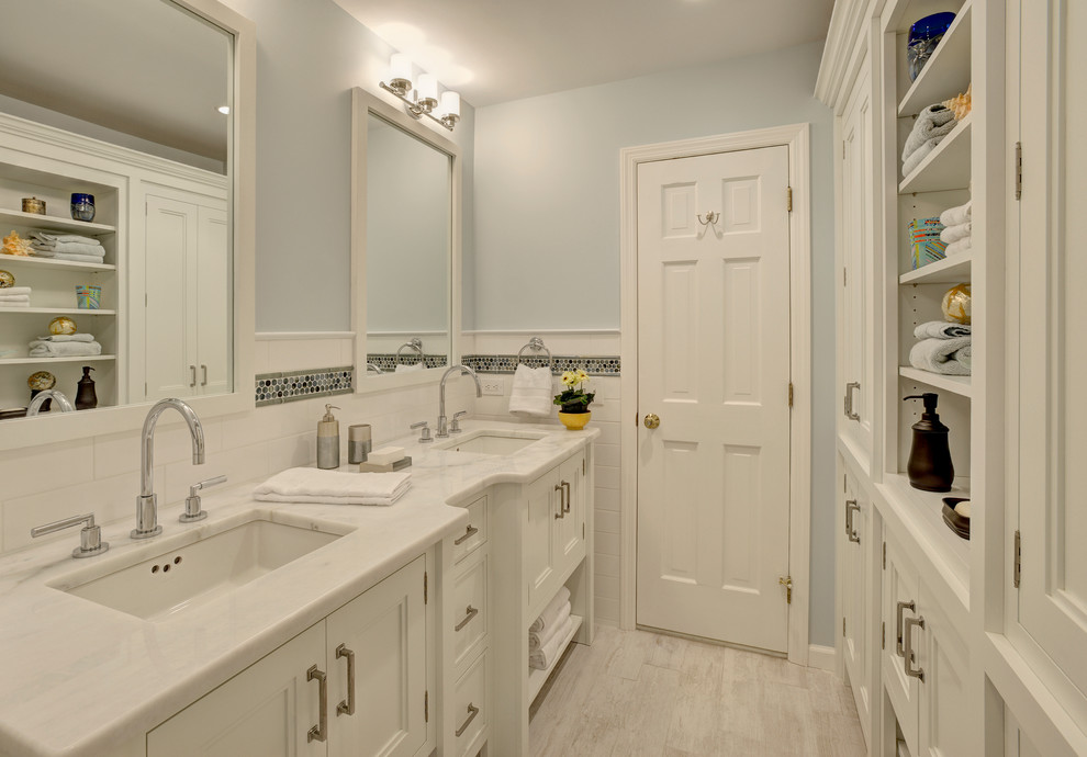 Mid-sized trendy kids' white tile and porcelain tile porcelain tile and gray floor bathroom photo in New York with recessed-panel cabinets, white cabinets, marble countertops, a one-piece toilet, an undermount sink and blue walls