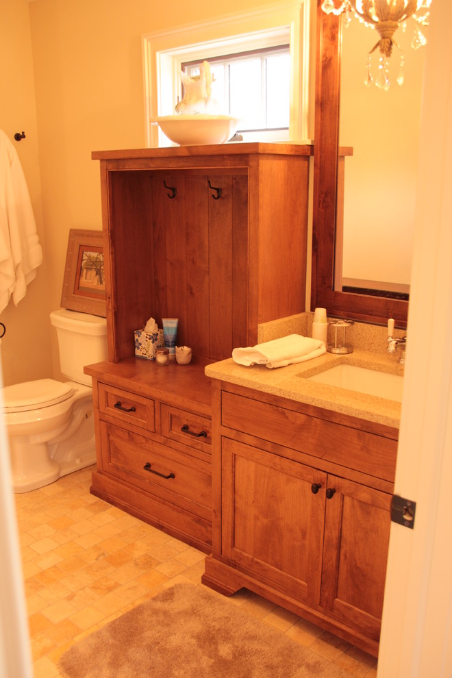 Design ideas for a large classic bathroom in Milwaukee with an integrated sink, recessed-panel cabinets, medium wood cabinets, concrete worktops, a built-in bath, a walk-in shower, a one-piece toilet, beige tiles, metro tiles, white walls and ceramic flooring.