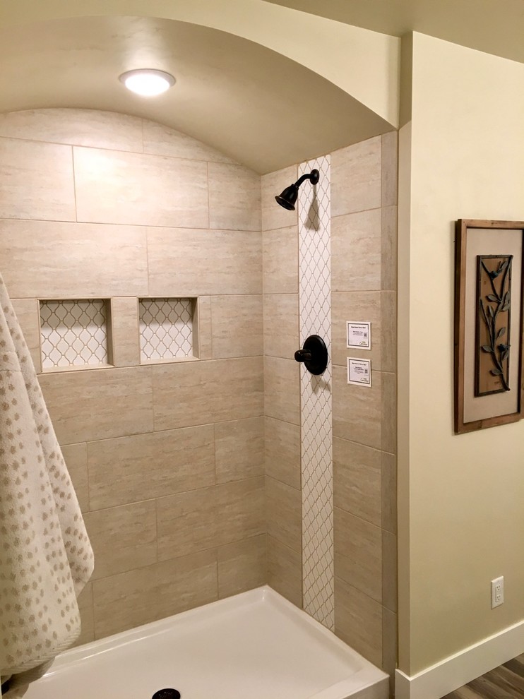 Design ideas for a medium sized classic shower room bathroom in Other with recessed-panel cabinets, white cabinets, a corner shower, beige tiles, beige walls, light hardwood flooring, a pedestal sink and limestone worktops.