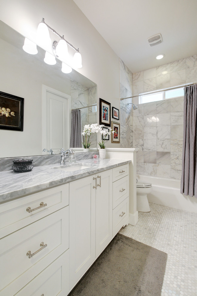 Medium sized victorian shower room bathroom in Austin with shaker cabinets, white cabinets, an alcove bath, a two-piece toilet, grey tiles, stone tiles, grey walls, marble flooring, a submerged sink and marble worktops.