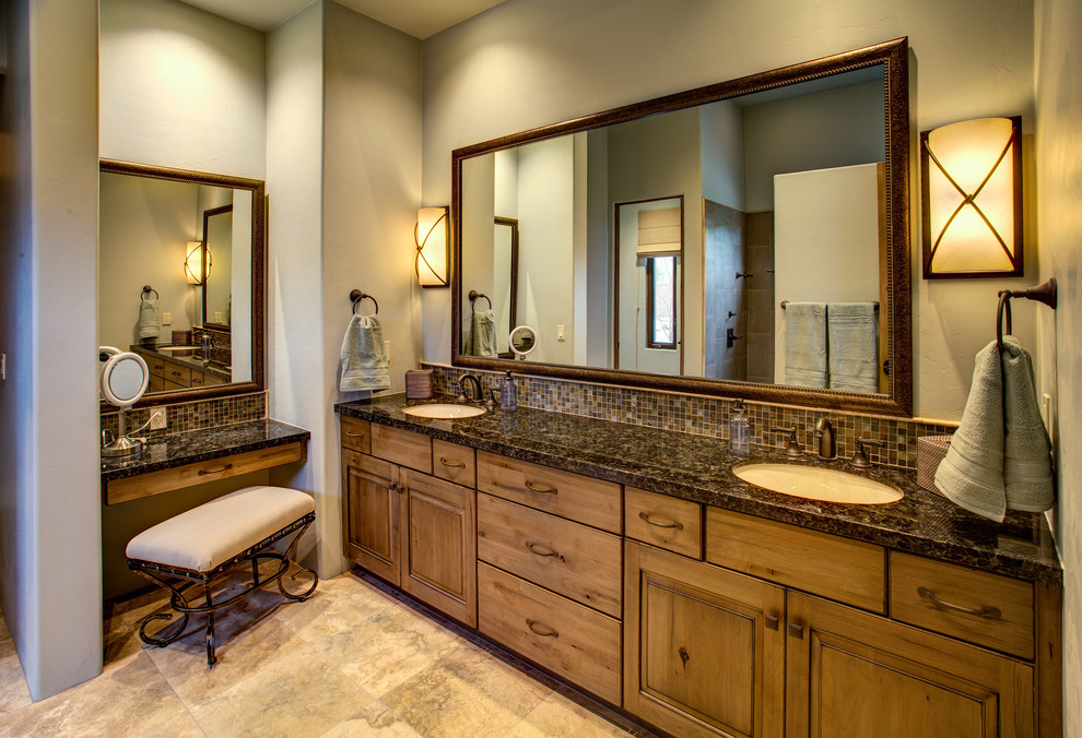 Medium sized ensuite bathroom in Phoenix with recessed-panel cabinets, medium wood cabinets, multi-coloured tiles, mosaic tiles, beige walls, limestone flooring, a submerged sink, granite worktops and beige floors.
