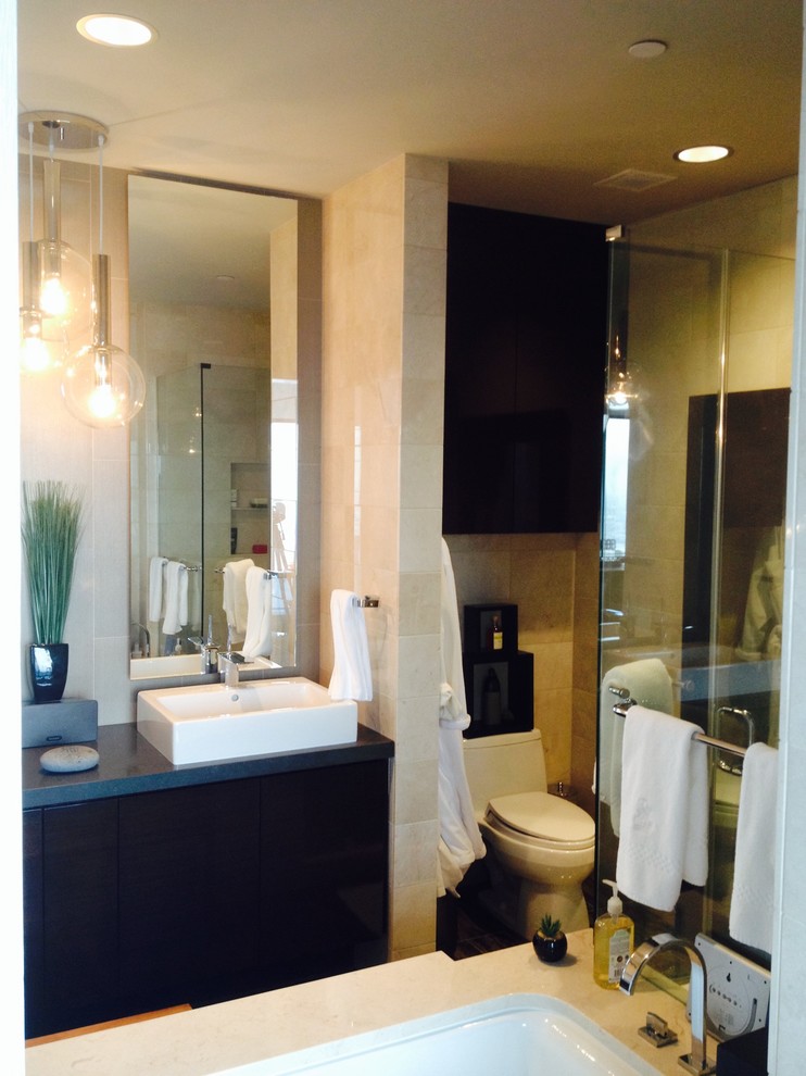 Exemple d'une salle de bain principale tendance avec une vasque, un placard à porte plane, un plan de toilette en quartz, une douche d'angle, WC à poser, un carrelage beige, des carreaux de porcelaine, un mur beige et un sol en carrelage de porcelaine.