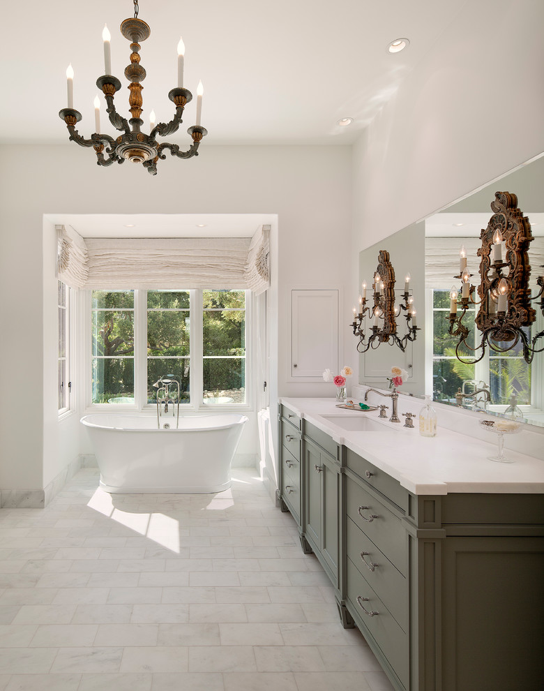 Inspiration for a huge mediterranean master porcelain tile freestanding bathtub remodel in Santa Barbara with recessed-panel cabinets, green cabinets, white walls and an undermount sink