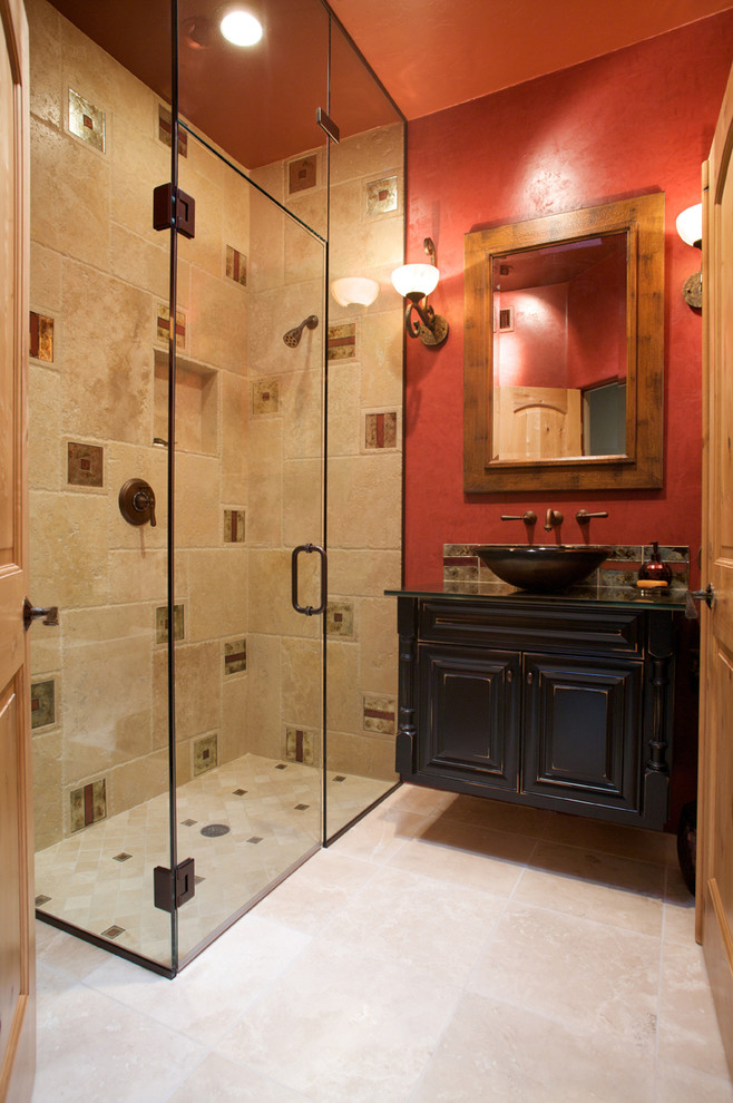 Idée de décoration pour une salle d'eau design en bois vieilli avec une vasque, un placard avec porte à panneau surélevé, un plan de toilette en verre, une douche à l'italienne, un carrelage beige, un mur rouge, un sol en travertin et un carrelage de pierre.