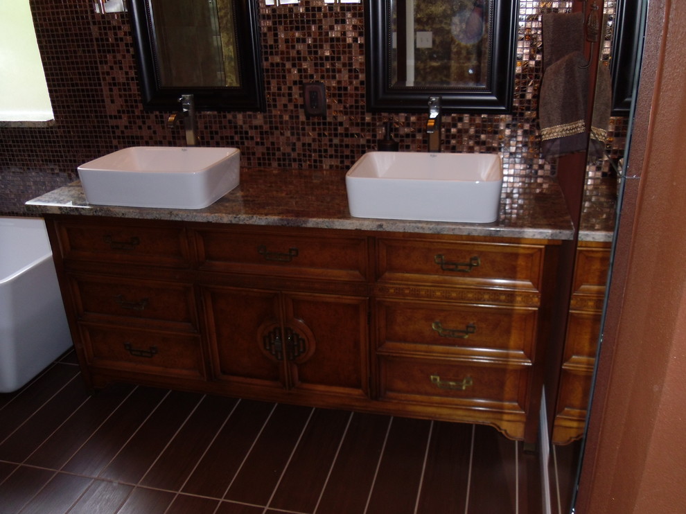 Example of a mid-sized master multicolored tile and glass tile porcelain tile bathroom design in Tampa with a vessel sink, furniture-like cabinets, medium tone wood cabinets, granite countertops and red walls