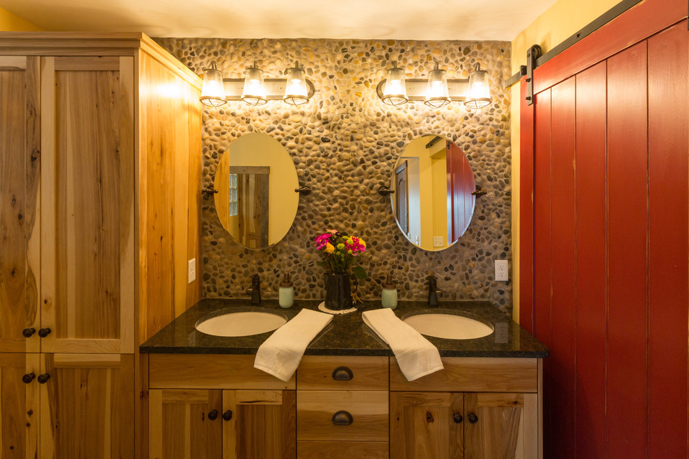 Rustik inredning av ett mellanstort en-suite badrum, med släta luckor, skåp i mellenmörkt trä, en öppen dusch, en toalettstol med separat cisternkåpa, flerfärgad kakel, kakel i småsten, flerfärgade väggar, klinkergolv i keramik, ett undermonterad handfat, granitbänkskiva, grått golv och med dusch som är öppen