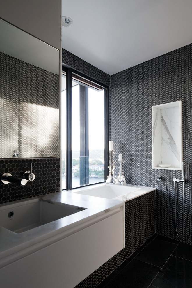 Contemporary bathroom in Sydney with black tiles and porcelain flooring.