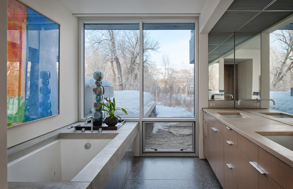 На фото: ванная комната в современном стиле с плоскими фасадами, светлыми деревянными фасадами, полновстраиваемой ванной, белыми стенами и врезной раковиной с