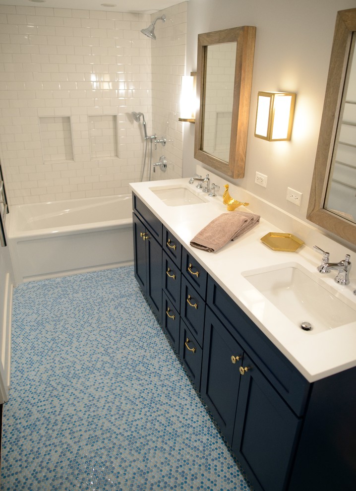 Photo of a small classic family bathroom in Chicago with engineered stone worktops, recessed-panel cabinets, an alcove bath, a shower/bath combination, blue tiles, mosaic tiles, white walls, mosaic tile flooring, a submerged sink and blue cabinets.