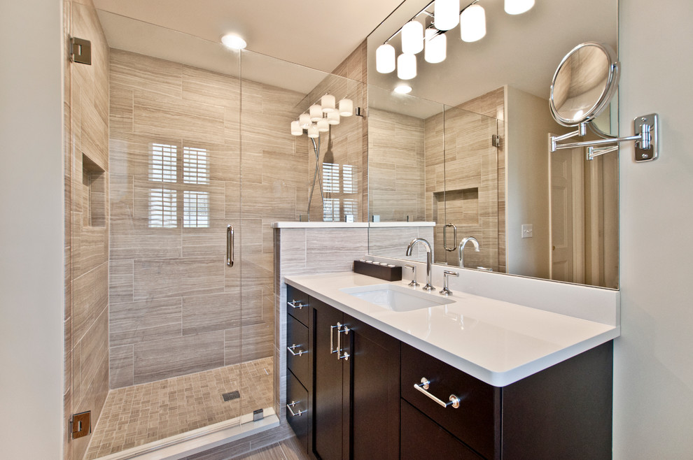 Alcove shower - small transitional master beige tile and porcelain tile porcelain tile and beige floor alcove shower idea in Nashville with shaker cabinets, dark wood cabinets, a two-piece toilet, gray walls, an undermount sink, quartz countertops, a hinged shower door and white countertops