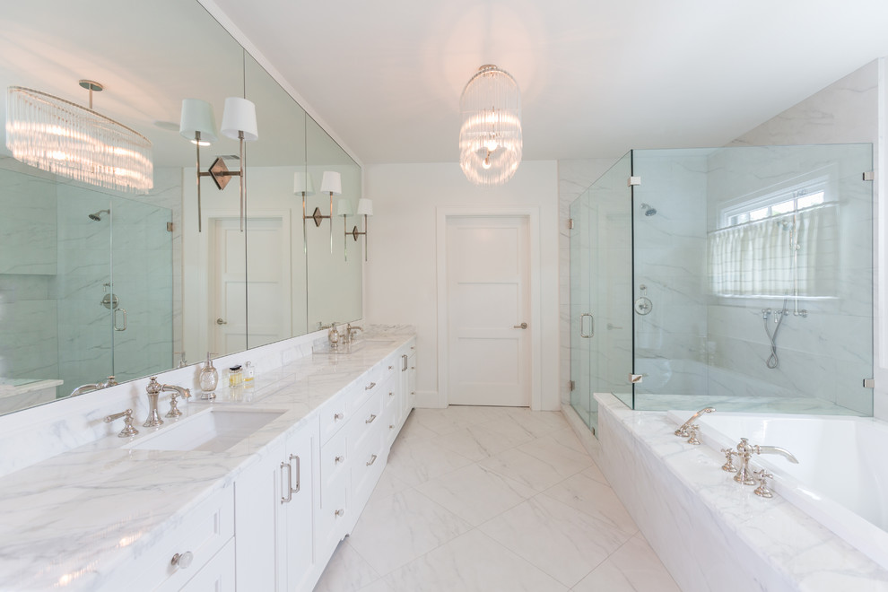 Example of a large transitional master white tile and stone slab marble floor bathroom design in Houston with recessed-panel cabinets, white cabinets, white walls, an undermount sink and marble countertops