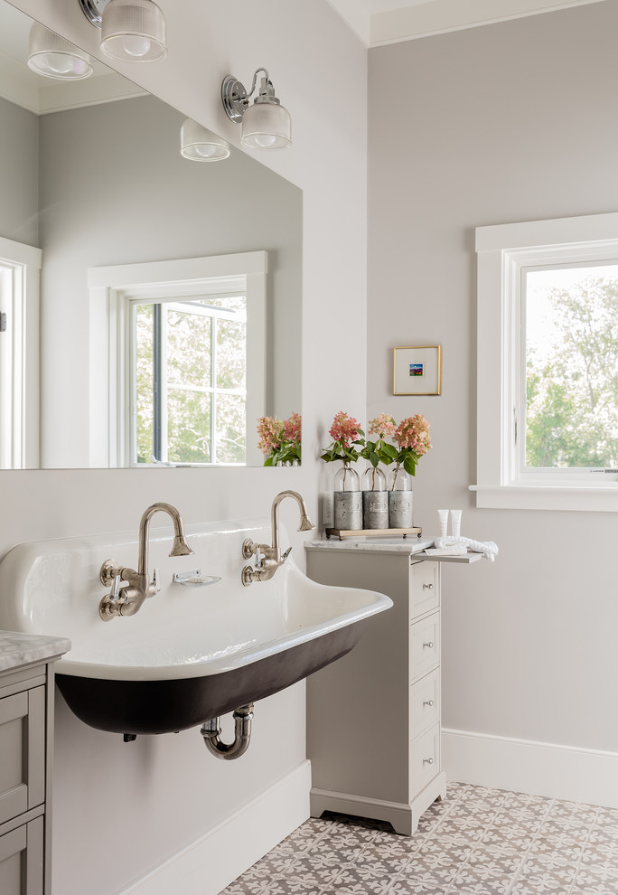 Medium sized farmhouse grey and cream family bathroom in Boston with porcelain flooring, a wall-mounted sink, grey floors, shaker cabinets, grey cabinets and grey walls.