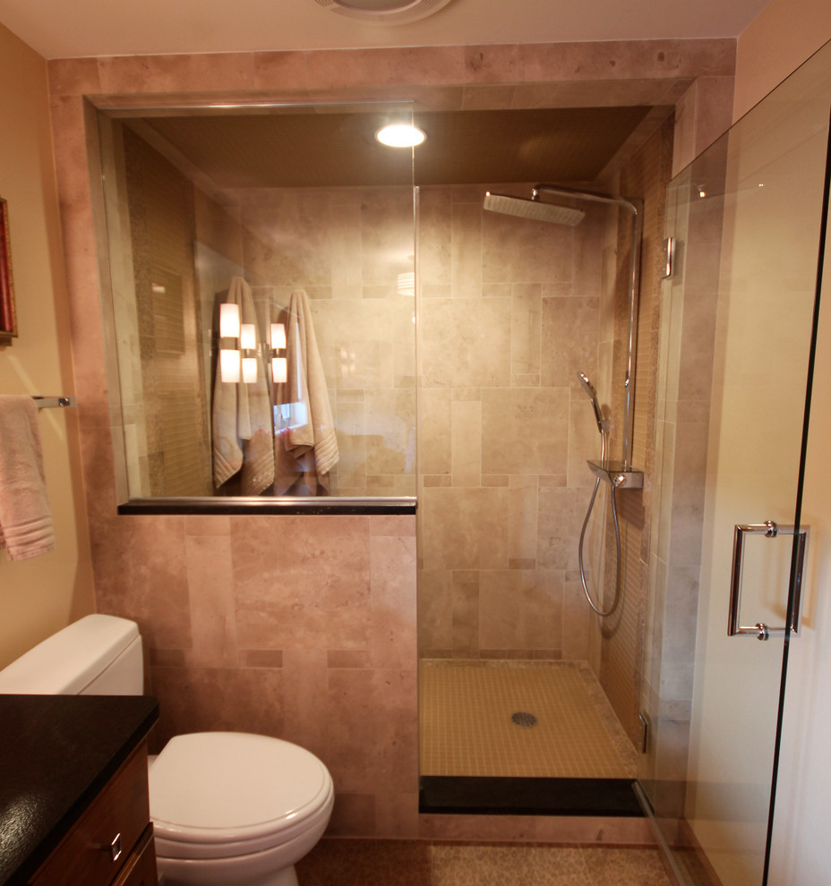 This is an example of a medium sized classic ensuite bathroom in Milwaukee with raised-panel cabinets, medium wood cabinets, an alcove shower, a two-piece toilet, a submerged sink, granite worktops, multi-coloured floors and a hinged door.