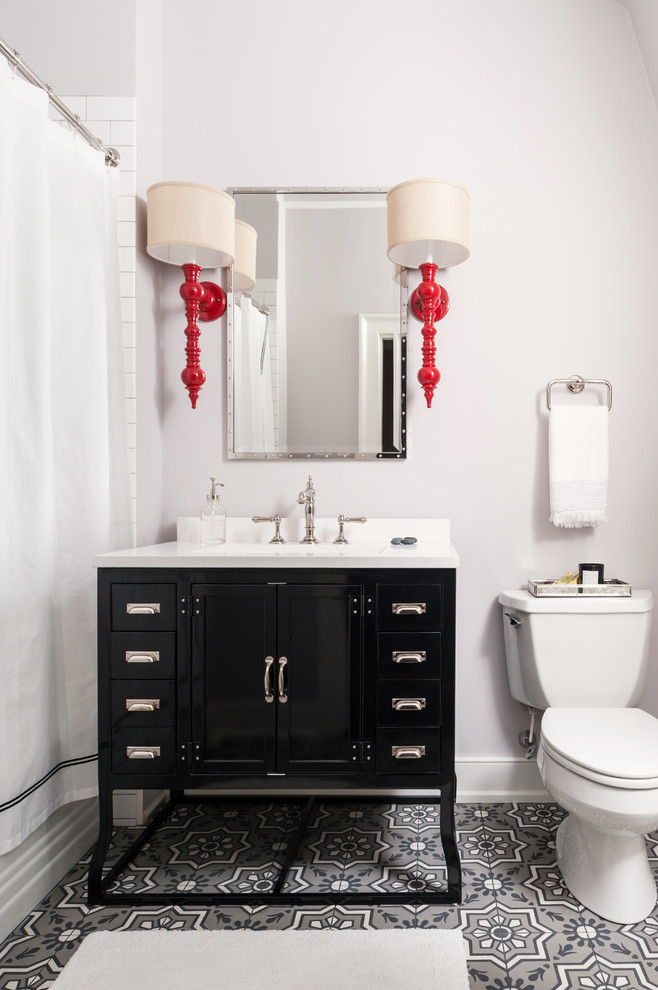 Inspiration for a traditional shower room bathroom in Richmond with black cabinets, a shower/bath combination, white tiles, cement flooring, a submerged sink, engineered stone worktops, white worktops, a two-piece toilet, beige walls, grey floors and shaker cabinets.