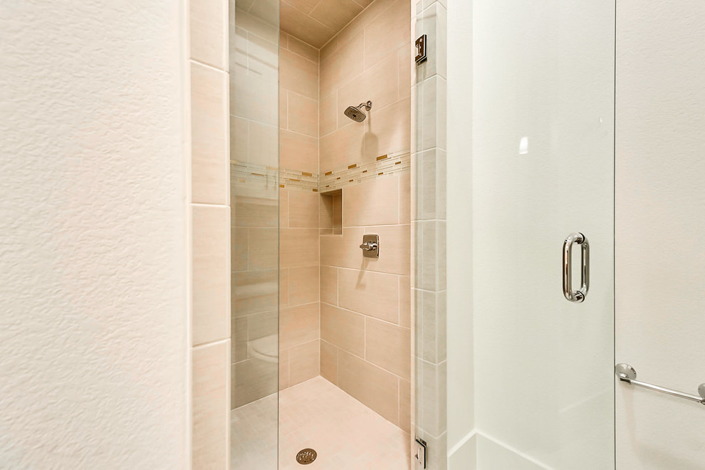 Medium sized classic shower room bathroom in Dallas with shaker cabinets, white cabinets, an alcove shower, a two-piece toilet, beige tiles, beige walls, ceramic flooring, a submerged sink and engineered stone worktops.
