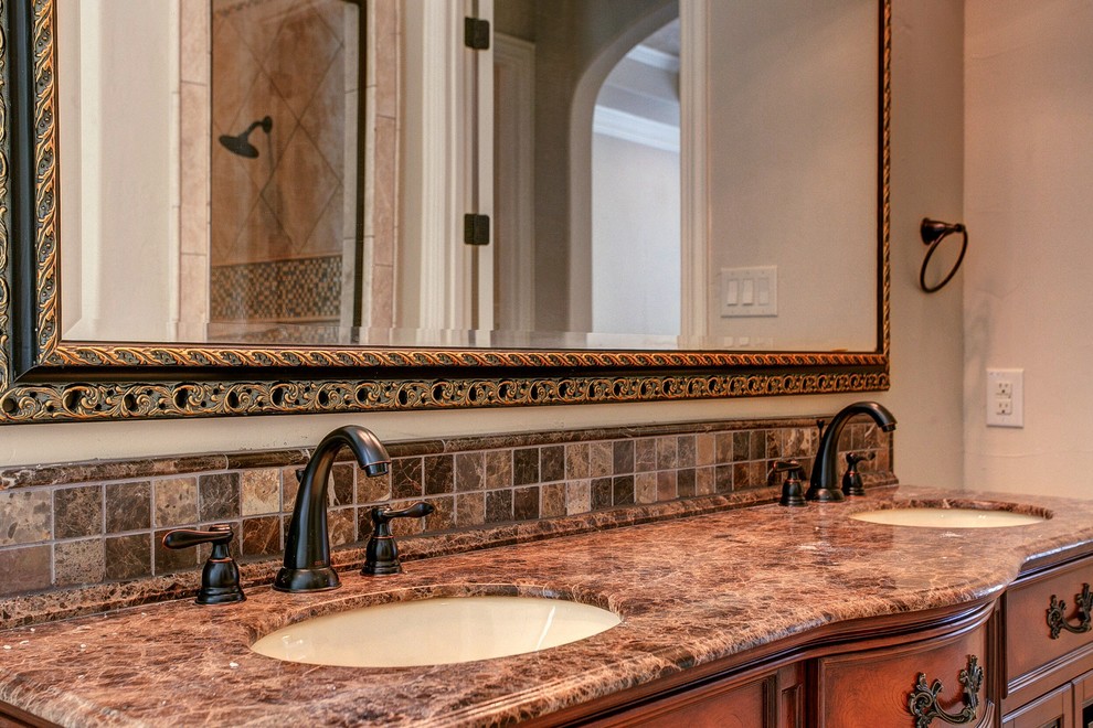 Mid-sized elegant master beige tile, brown tile, multicolored tile and mosaic tile travertine floor bathroom photo in Dallas with furniture-like cabinets, dark wood cabinets, a two-piece toilet, beige walls, an undermount sink and granite countertops