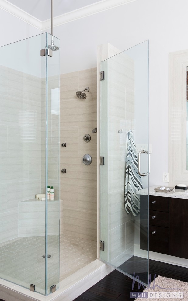 Photo of a medium sized contemporary ensuite bathroom in Little Rock with flat-panel cabinets, dark wood cabinets, a corner shower, a two-piece toilet, beige tiles, porcelain tiles, beige walls, dark hardwood flooring, a submerged sink and engineered stone worktops.