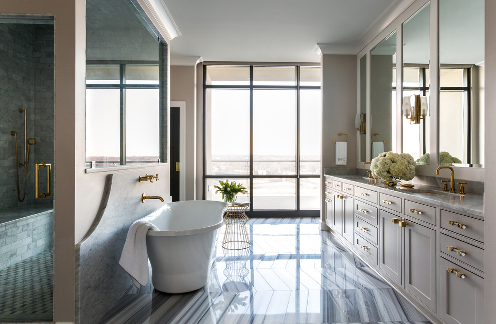 Идея дизайна: большая главная ванная комната в стиле неоклассика (современная классика) с накладной раковиной, мраморной столешницей, отдельно стоящей ванной, бежевой плиткой, бежевыми стенами, мраморным полом, серыми фасадами и душем в нише