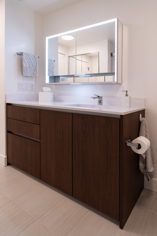 Medium sized modern ensuite bathroom in Portland with flat-panel cabinets, medium wood cabinets, an alcove shower, a one-piece toilet, white walls, porcelain flooring, an integrated sink, engineered stone worktops, beige floors, a sliding door, white worktops, a single sink and a built in vanity unit.