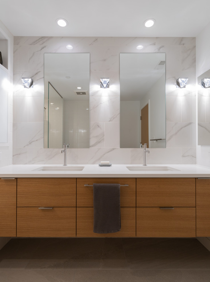 Large minimalist kids' multicolored tile and ceramic tile porcelain tile and gray floor bathroom photo in Cincinnati with flat-panel cabinets, light wood cabinets, an undermount tub, a one-piece toilet, white walls, an undermount sink, quartz countertops and white countertops