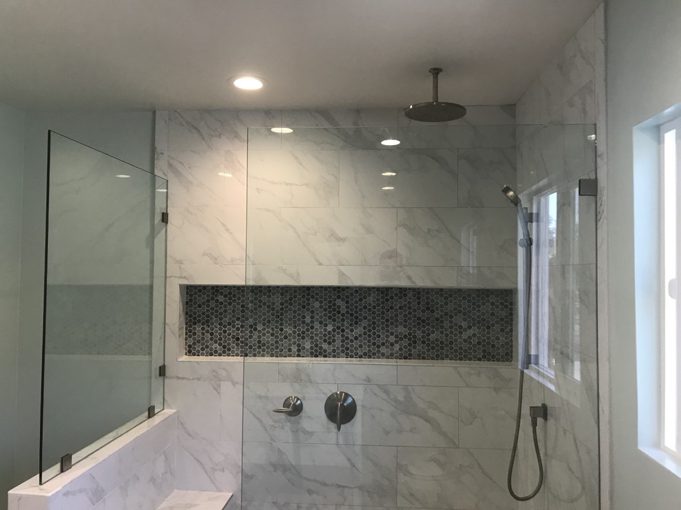 Design ideas for a large contemporary ensuite bathroom in Los Angeles with white cabinets, a walk-in shower, a two-piece toilet, white tiles, marble tiles, slate flooring, a submerged sink, marble worktops, black floors, an open shower, grey worktops, blue walls, freestanding cabinets, a wall niche, a shower bench, double sinks and a built in vanity unit.