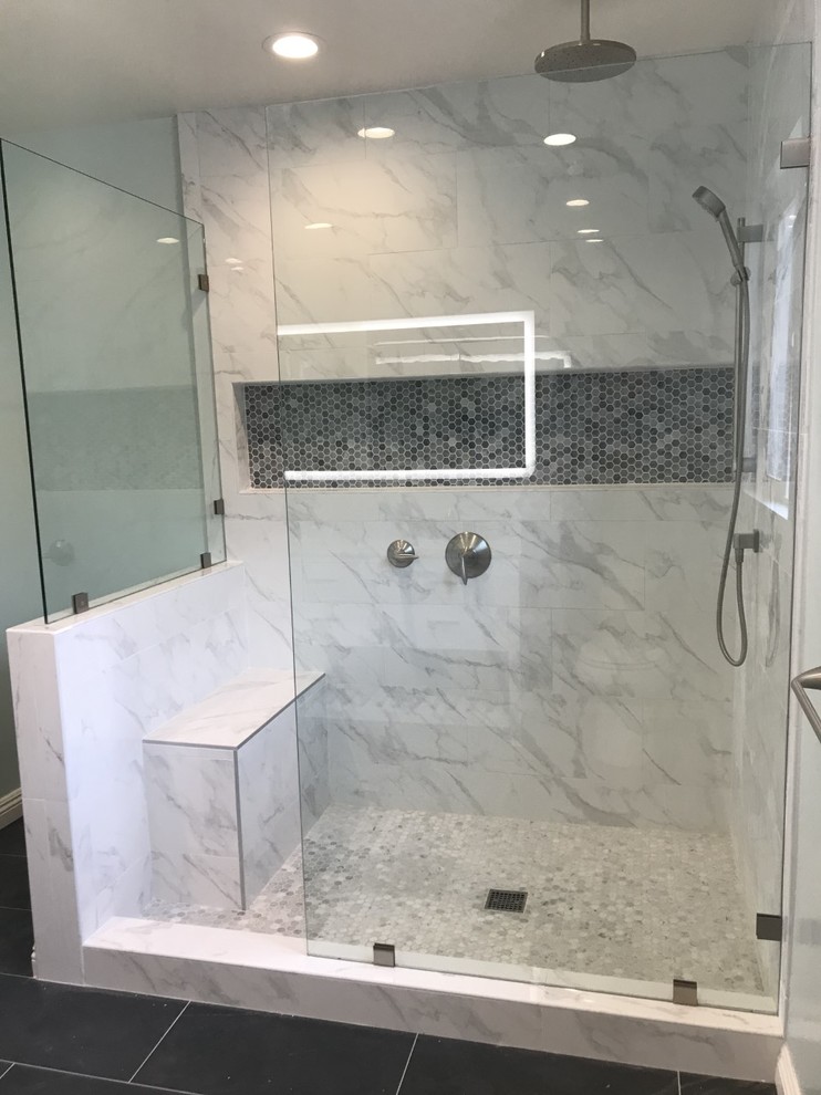 Inspiration for a large contemporary ensuite bathroom in Los Angeles with white cabinets, a walk-in shower, a two-piece toilet, white tiles, marble tiles, slate flooring, a submerged sink, marble worktops, black floors, an open shower, grey worktops, blue walls, freestanding cabinets, a wall niche, a shower bench, double sinks and a built in vanity unit.