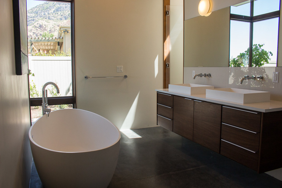 Inspiration for a mid-sized modern master white tile and ceramic tile concrete floor bathroom remodel in Salt Lake City with flat-panel cabinets, dark wood cabinets, quartz countertops, a two-piece toilet and white walls