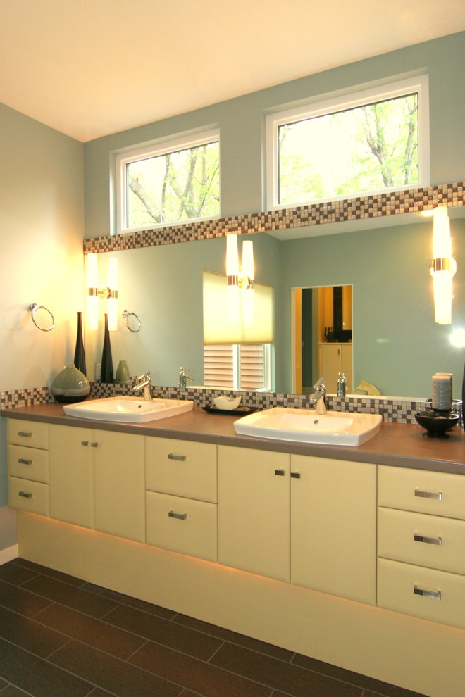 Пример оригинального дизайна: главная ванная комната среднего размера в современном стиле с накладной раковиной, плоскими фасадами, желтыми фасадами, столешницей из ламината, разноцветной плиткой, синими стенами и полом из керамогранита