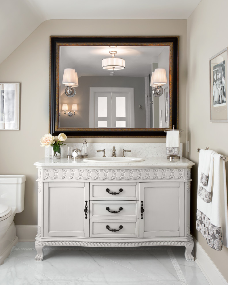 Example of a classic bathroom design in Vancouver with a drop-in sink and recessed-panel cabinets