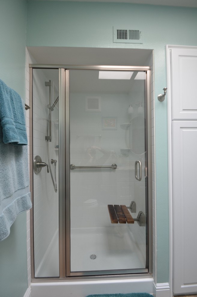 Inspiration for a mid-sized transitional 3/4 light wood floor alcove shower remodel in San Francisco with white cabinets, blue walls, raised-panel cabinets, a two-piece toilet, an undermount sink and granite countertops