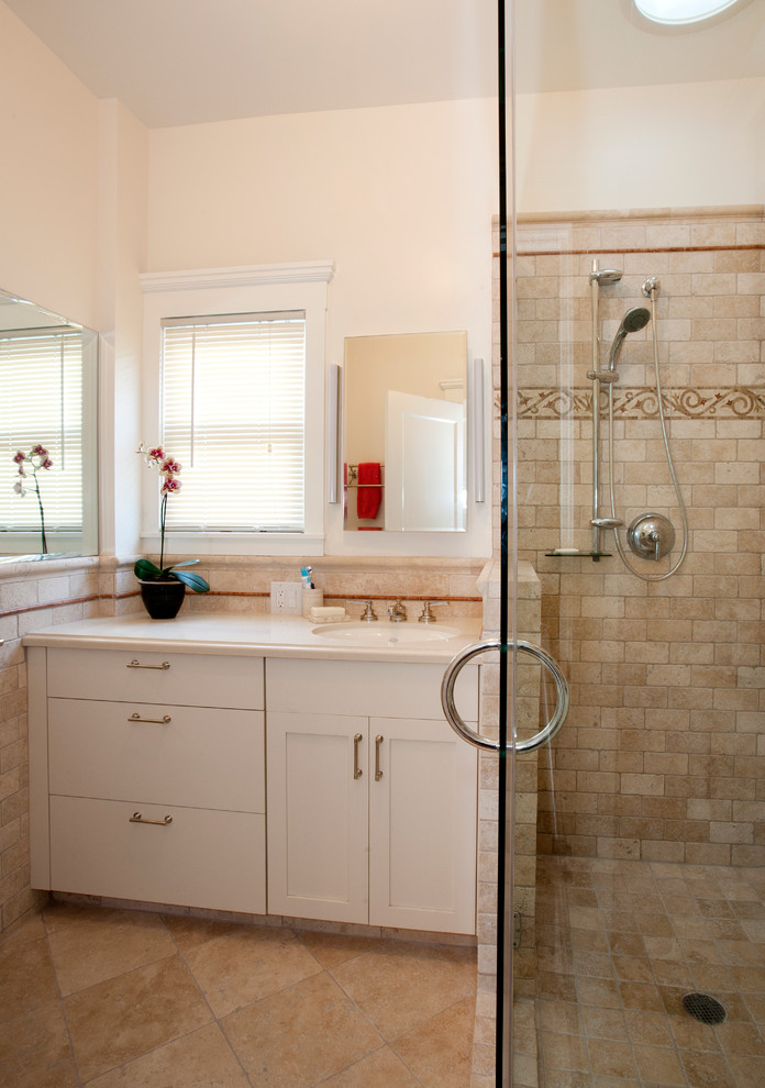 Inspiration for a small timeless master beige tile and stone tile travertine floor and beige floor corner shower remodel in San Francisco with an undermount sink, shaker cabinets, quartzite countertops, a one-piece toilet, beige cabinets, beige walls, a hinged shower door and beige countertops