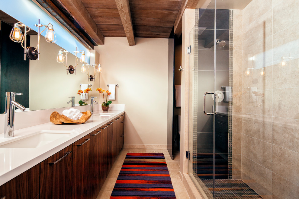 На фото: ванная комната в стиле фьюжн с врезной раковиной, плоскими фасадами, темными деревянными фасадами, душем в нише и бежевой плиткой с