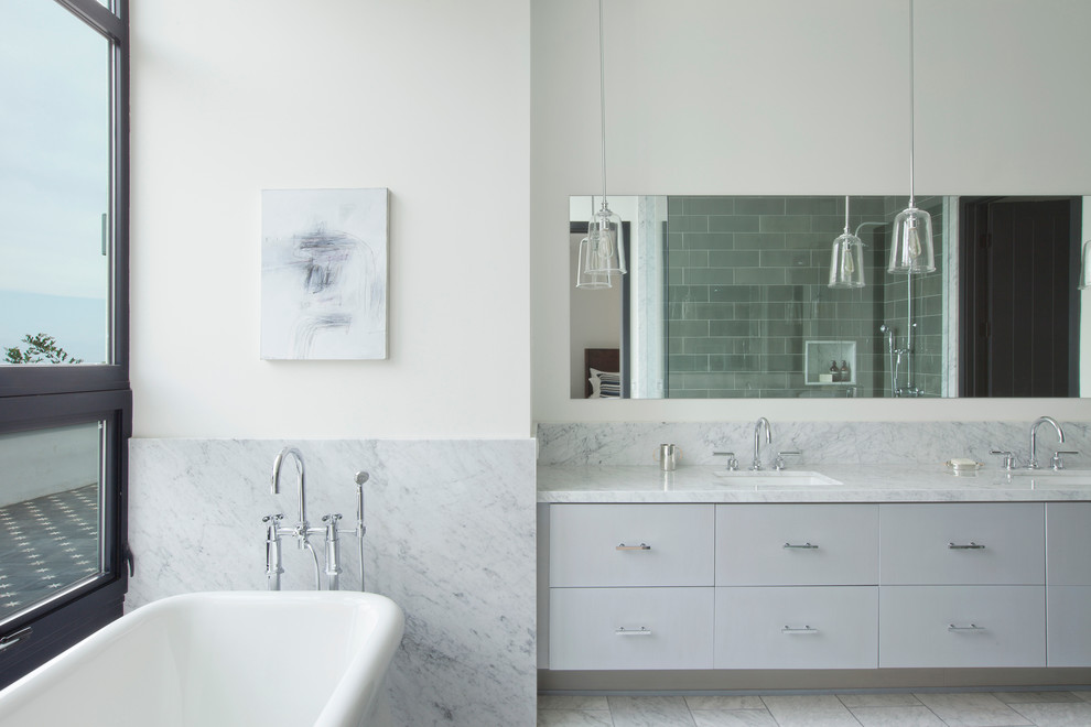 Photo of a contemporary bathroom in Los Angeles with flat-panel cabinets, grey cabinets, grey tiles and metro tiles.