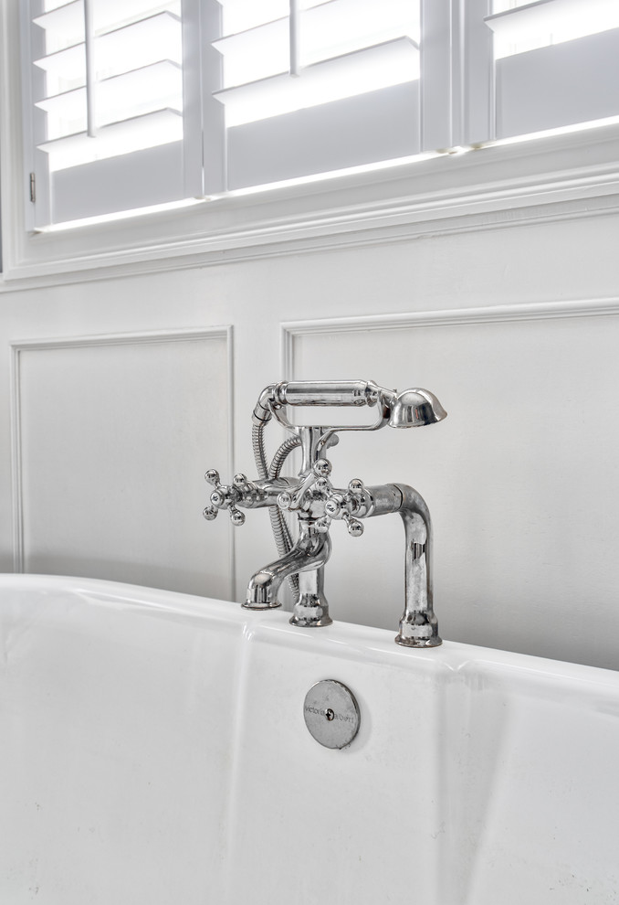 Photo of a large classic ensuite bathroom in New York with beaded cabinets, white cabinets, a freestanding bath, an alcove shower, a two-piece toilet, grey walls, marble flooring, a submerged sink, marble worktops, white floors, a hinged door and white worktops.