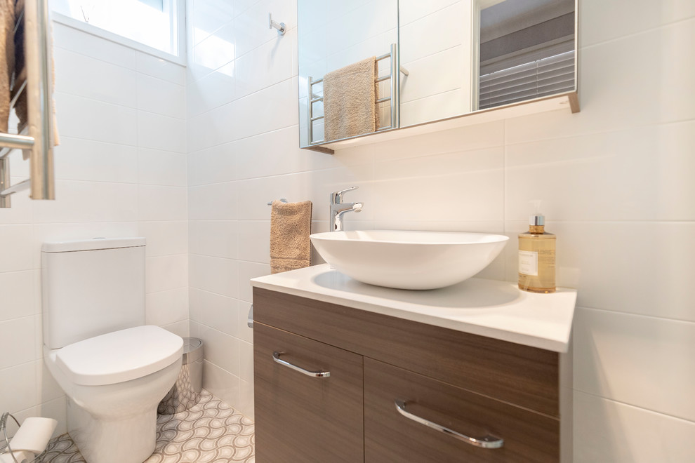 Medium sized contemporary ensuite bathroom in Sydney with raised-panel cabinets, light wood cabinets, a freestanding bath, a corner shower, a two-piece toilet, white tiles, ceramic tiles, white walls, porcelain flooring, a vessel sink, engineered stone worktops, multi-coloured floors, a hinged door and multi-coloured worktops.