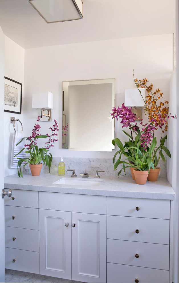 Inspiration for a mid-sized transitional master gray tile and stone tile marble floor bathroom remodel in Los Angeles with beaded inset cabinets, white cabinets, a wall-mount toilet, white walls, an undermount sink and marble countertops
