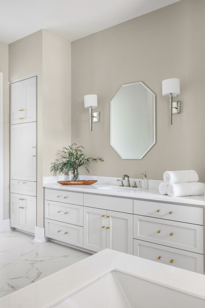 This is an example of a large traditional ensuite bathroom in Austin with shaker cabinets, grey cabinets, a submerged bath, a walk-in shower, white tiles, porcelain tiles, beige walls, porcelain flooring, a submerged sink, granite worktops, white floors, an open shower, white worktops, a single sink and a built in vanity unit.