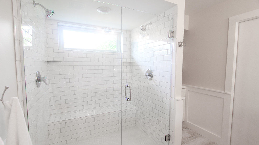 Double shower - mid-sized country master white tile and subway tile vinyl floor and gray floor double shower idea in Minneapolis with brown cabinets, a two-piece toilet, white walls, an undermount sink, marble countertops, a hinged shower door and white countertops