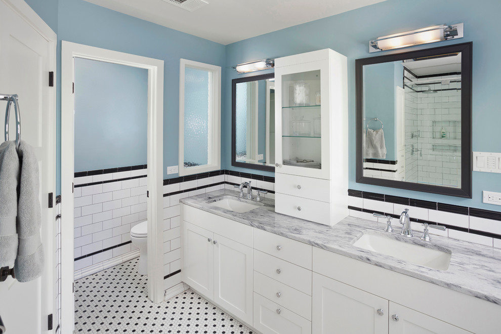Example of a 1950s white tile and subway tile mosaic tile floor bathroom design in Austin with an undermount sink, shaker cabinets, white cabinets, solid surface countertops, a one-piece toilet and blue walls