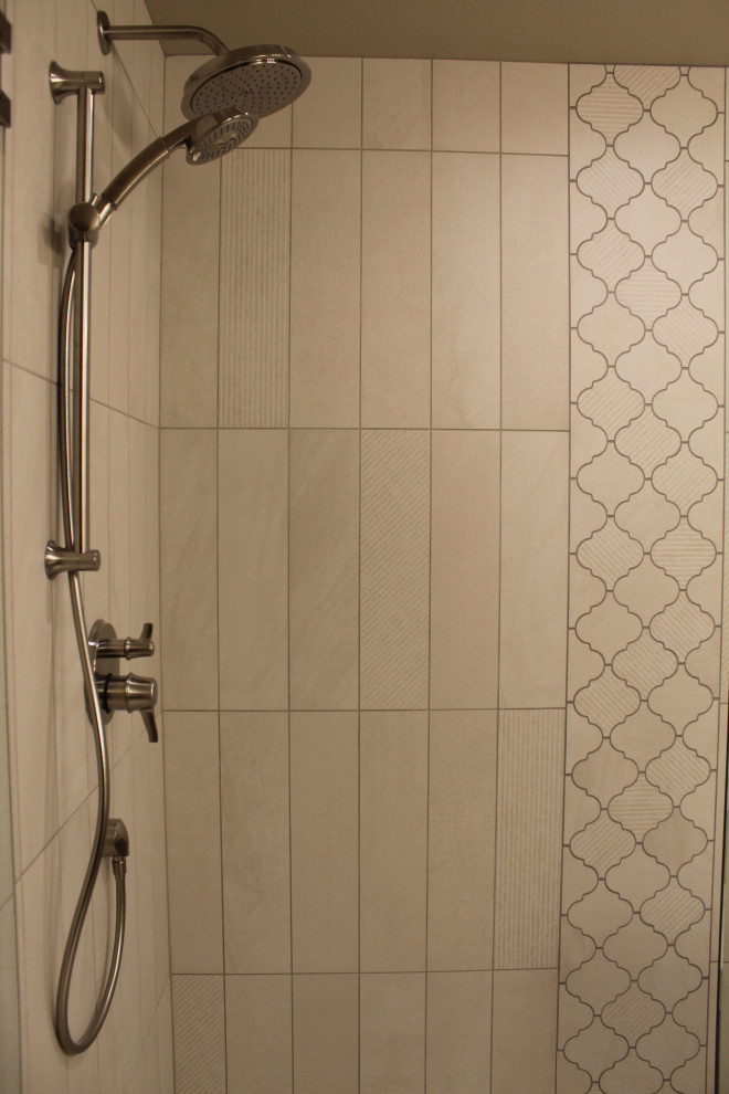 Inspiration for a mid-sized transitional master beige tile and ceramic tile ceramic tile and beige floor alcove shower remodel in Seattle with recessed-panel cabinets, white cabinets, a one-piece toilet, beige walls, an undermount sink, quartz countertops, a hinged shower door and beige countertops