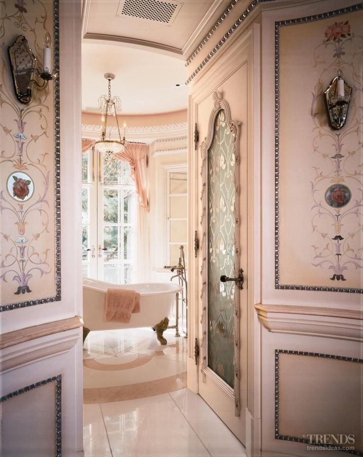 Inspiration for an expansive victorian ensuite bathroom in Miami with freestanding cabinets, a freestanding bath, pink walls, marble flooring and pink floors.