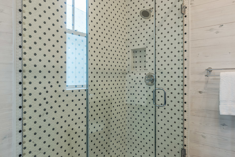 Example of a large beach style 3/4 multicolored tile and porcelain tile corner shower design in Miami with beige walls