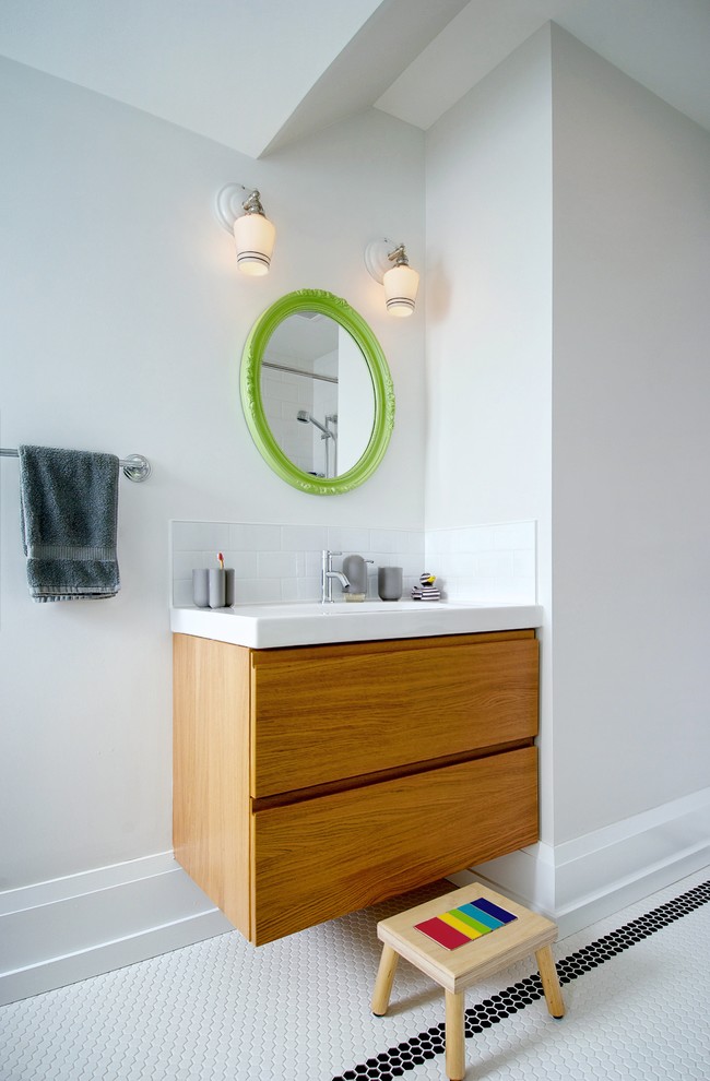 Bathroom - mid-sized contemporary kids' white tile and mosaic tile mosaic tile floor and white floor bathroom idea in Toronto with flat-panel cabinets, medium tone wood cabinets, solid surface countertops, white walls, a two-piece toilet, an undermount sink and white countertops