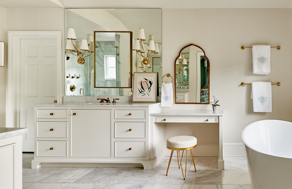 Inspiration for an expansive traditional ensuite bathroom in Other with a freestanding bath, a walk-in shower, a two-piece toilet, white tiles, marble tiles, marble flooring, a submerged sink, marble worktops, white floors, a hinged door, white cabinets and beige walls.